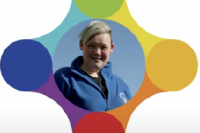 A women in a blue fleece appears in a colourful logo.